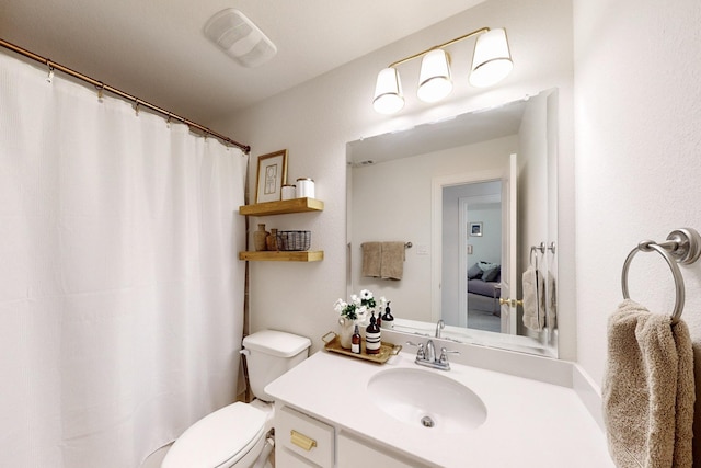 full bathroom with vanity, a shower with shower curtain, toilet, and visible vents