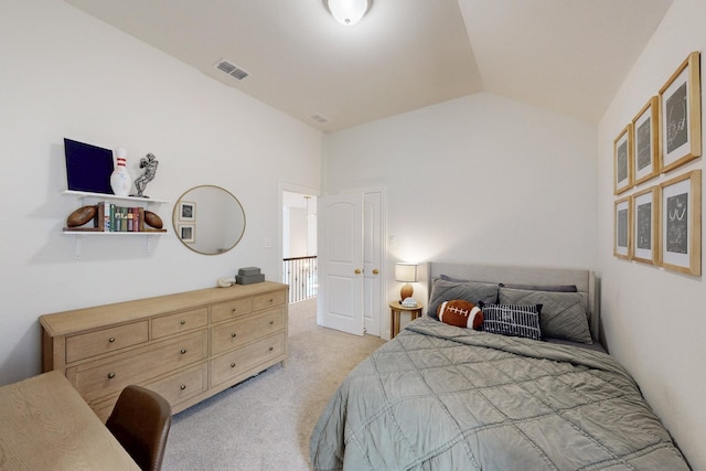 bedroom featuring visible vents, vaulted ceiling, and light carpet