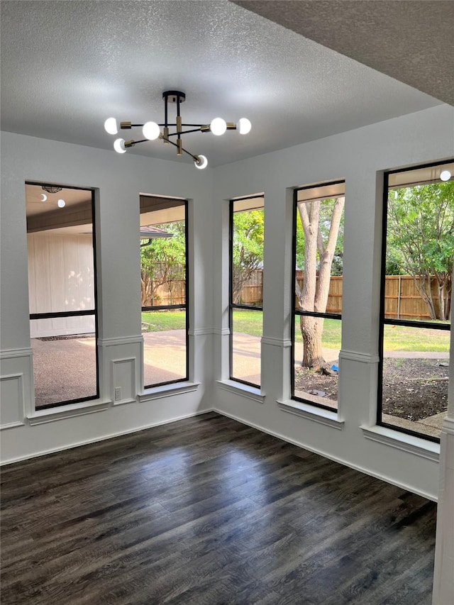 1441 Marlene Pl, Desoto, TX 75115 - unfurnished dining area with a textured ceiling, wood finished floors, and a chandelier