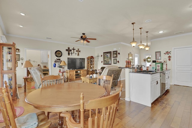 dining room with baseboards, ornamental molding, ceiling fan, and wood finished floors