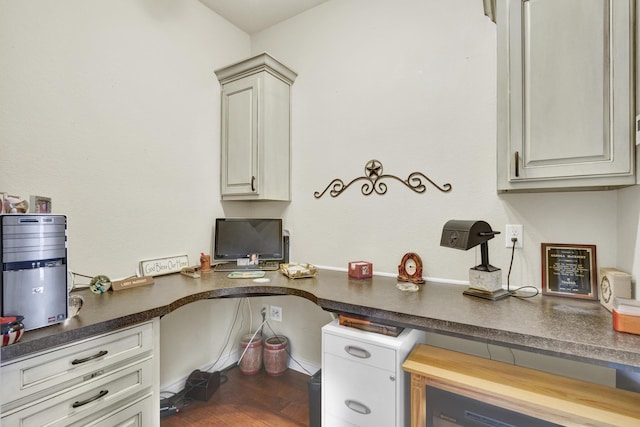 office space with built in desk and wood finished floors