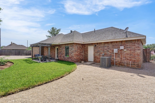 rear view of property with a yard, a patio area, fence, and a pergola