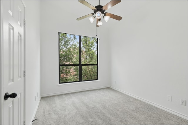 spare room featuring carpet floors, ceiling fan, and baseboards