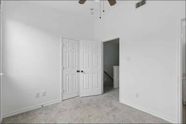 unfurnished bedroom with ceiling fan, carpet, baseboards, visible vents, and a closet