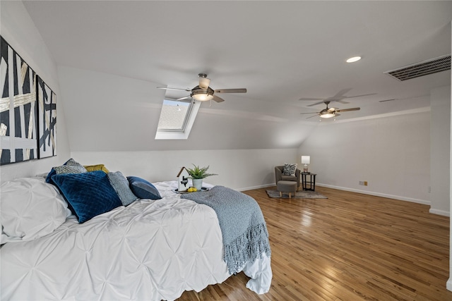 bedroom with vaulted ceiling with skylight, light wood-style floors, recessed lighting, baseboards, and visible vents