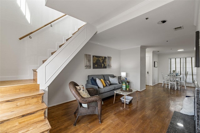 living area with stairway, crown molding, wood finished floors, and visible vents