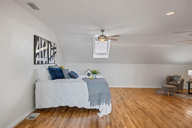 bedroom with visible vents, vaulted ceiling, and light wood-style floors