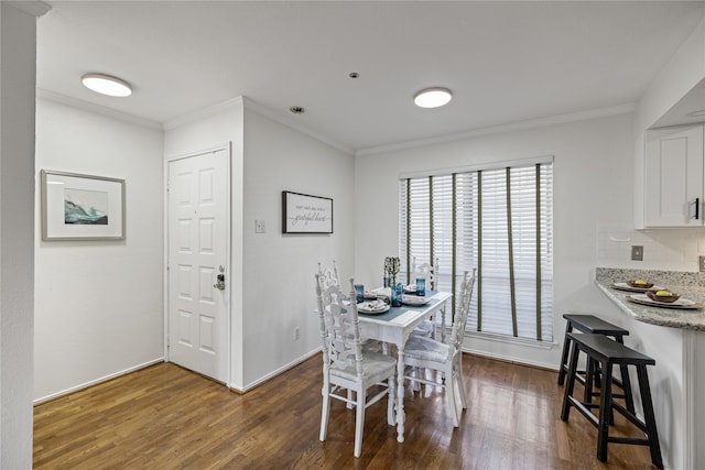 dining space with dark wood-style floors and ornamental molding