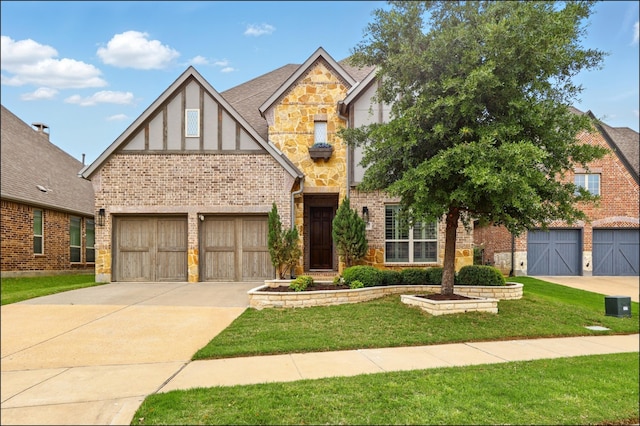english style home with concrete driveway, brick siding, stone siding, and a front lawn