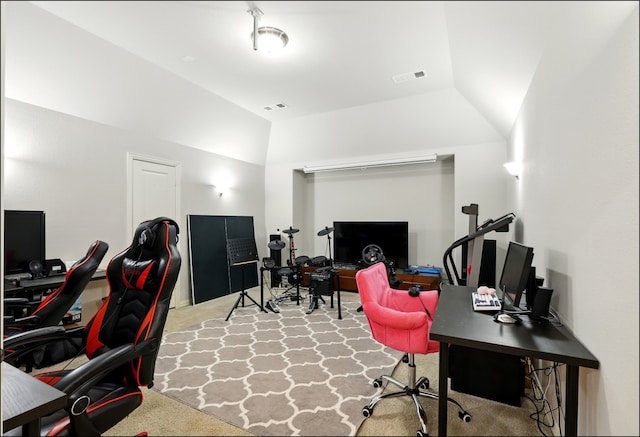 carpeted home office featuring visible vents and lofted ceiling