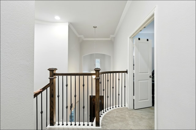 corridor with crown molding, carpet, and an upstairs landing