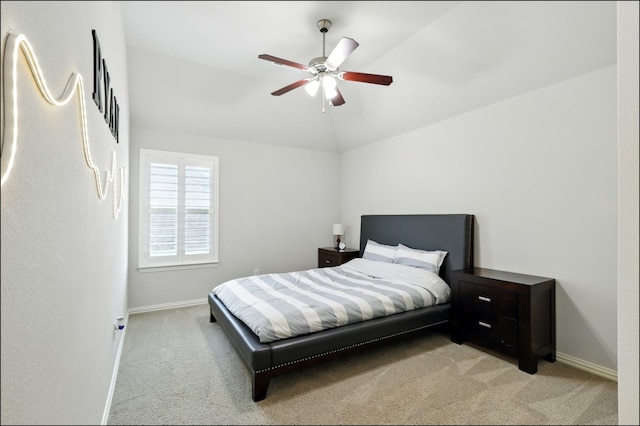 bedroom with baseboards, light carpet, and lofted ceiling