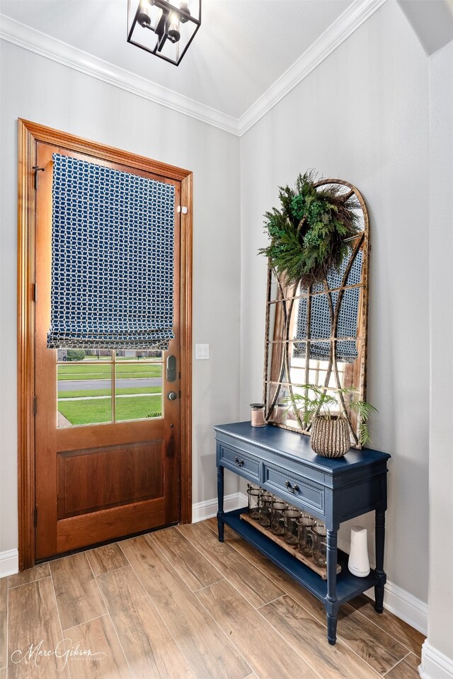 laundry area featuring visible vents, crown molding, washing machine and dryer, cabinet space, and light wood-style flooring