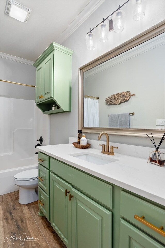 bathroom with double vanity, a ceiling fan, a sink, and ornamental molding
