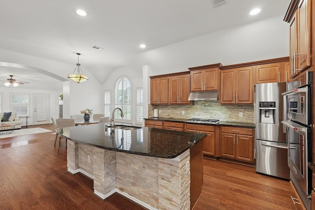 5729 New Castle Dr, Richardson, TX 75082 - kitchen with a sink, dark wood finished floors, stainless steel appliances, under cabinet range hood, and visible vents