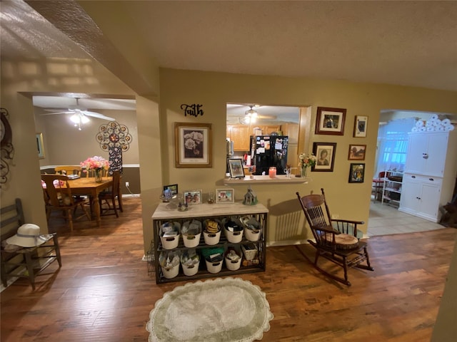 dining space featuring ceiling fan and wood finished floors