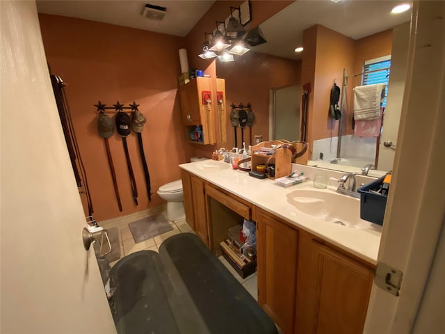 full bathroom featuring visible vents, a sink, tile patterned floors, toilet, and a shower with door
