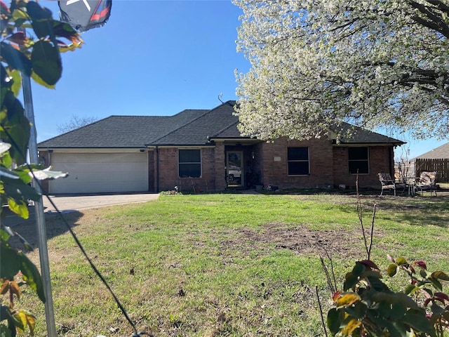 ranch-style house with a garage, a front yard, brick siding, a shingled roof, and driveway