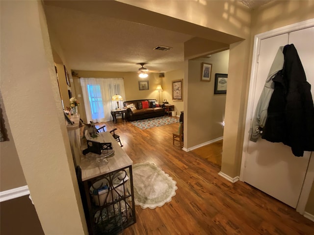 interior space with baseboards, visible vents, and wood finished floors