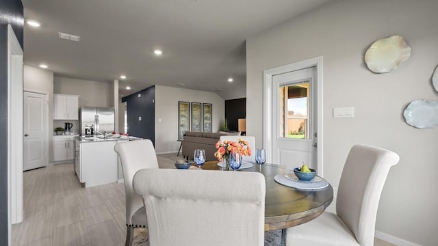 dining area featuring recessed lighting and baseboards