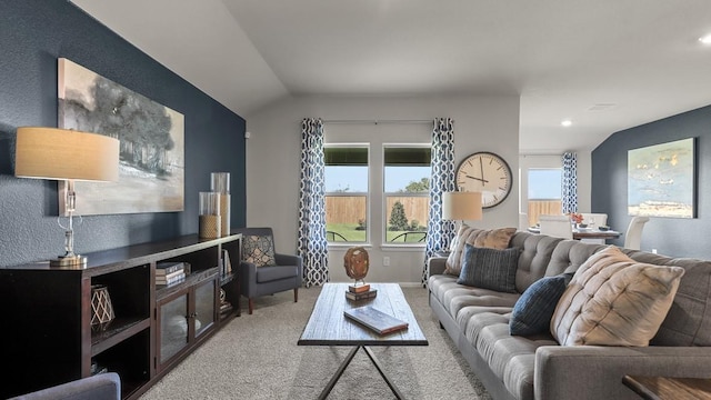 carpeted living area featuring lofted ceiling