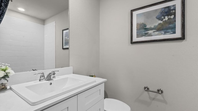bathroom featuring recessed lighting, vanity, and toilet