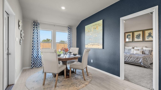 dining area featuring baseboards, recessed lighting, a textured wall, and vaulted ceiling