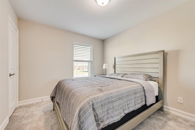 carpeted bedroom featuring baseboards