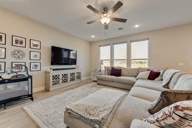 living room featuring recessed lighting, ceiling fan, visible vents, and light wood finished floors