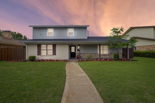traditional-style home with roof with shingles and brick siding
