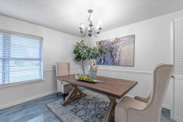 dining area featuring a chandelier, a textured ceiling, and baseboards