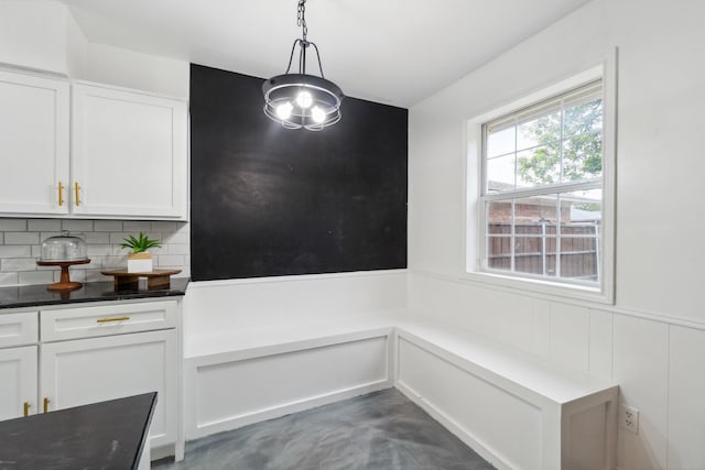 unfurnished dining area with finished concrete flooring