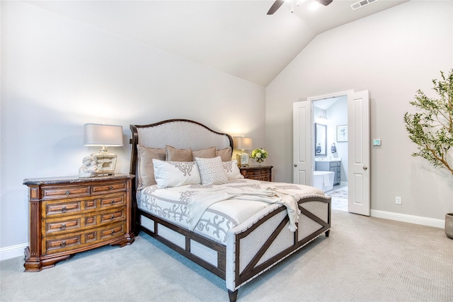 bedroom featuring light carpet, visible vents, baseboards, ensuite bathroom, and vaulted ceiling