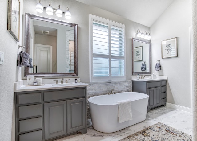 full bathroom with visible vents, a sink, marble finish floor, and a freestanding bath
