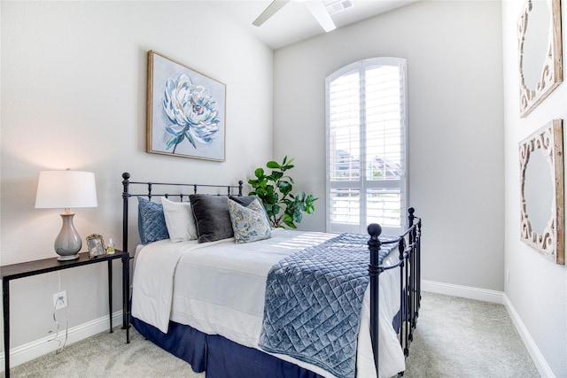 carpeted bedroom featuring baseboards, visible vents, multiple windows, and ceiling fan