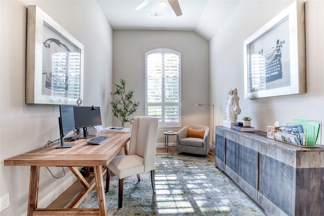 office space featuring vaulted ceiling, a ceiling fan, and visible vents