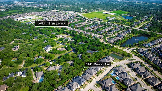 bird's eye view featuring a water view and a residential view