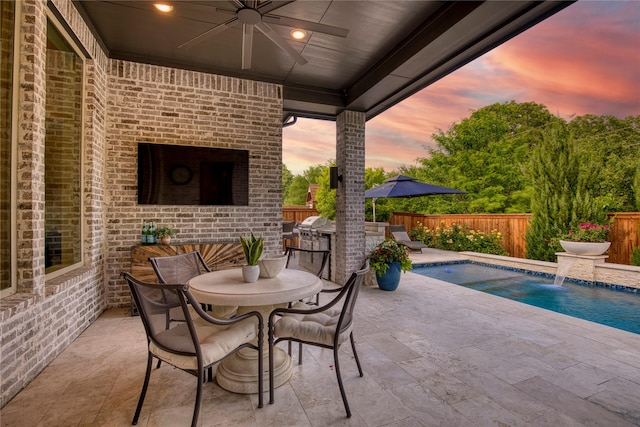view of patio with outdoor dining area, a fenced in pool, a ceiling fan, and a fenced backyard