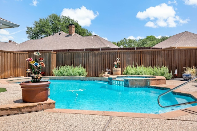 view of swimming pool with a fenced backyard and a pool with connected hot tub