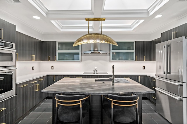 kitchen featuring a sink, wall chimney exhaust hood, appliances with stainless steel finishes, and dark tile patterned flooring