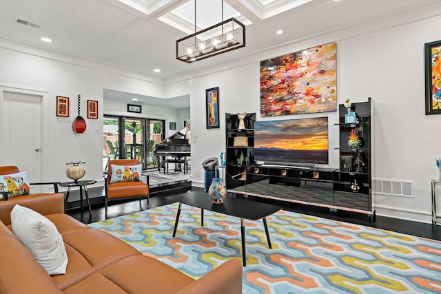 living room with crown molding, a notable chandelier, wood finished floors, and visible vents