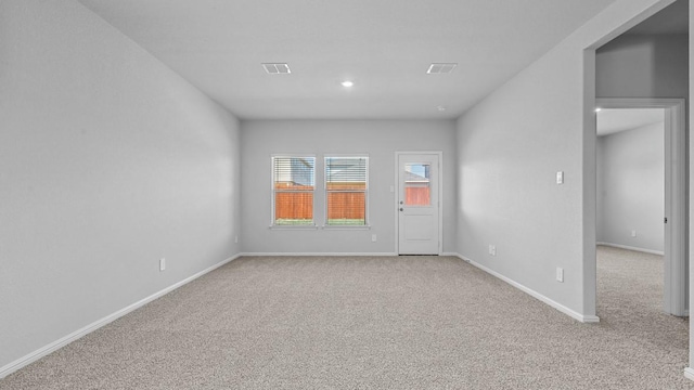carpeted empty room featuring baseboards, recessed lighting, and visible vents