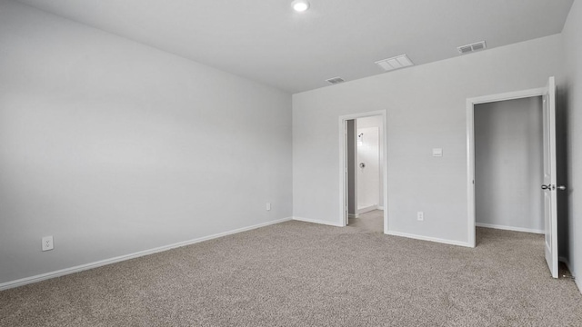 unfurnished bedroom with visible vents, carpet, and baseboards