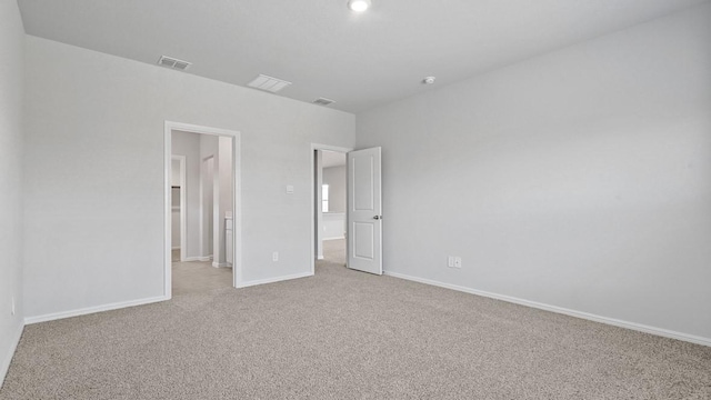 unfurnished bedroom with visible vents, baseboards, and light carpet