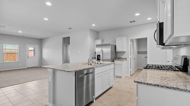 kitchen featuring a sink, stainless steel appliances, open floor plan, light tile patterned floors, and visible vents
