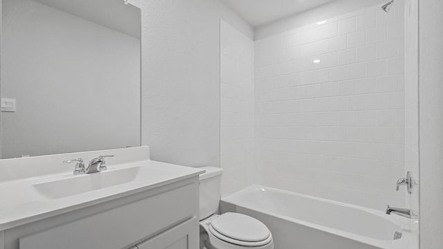 full bath featuring vanity, shower / bathing tub combination, a textured wall, and toilet