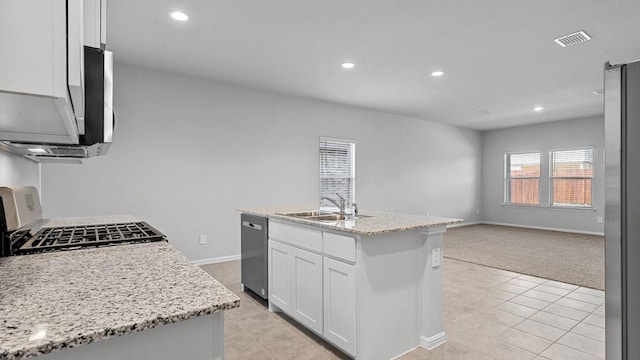 kitchen with a sink, light tile patterned floors, white cabinets, and stainless steel appliances