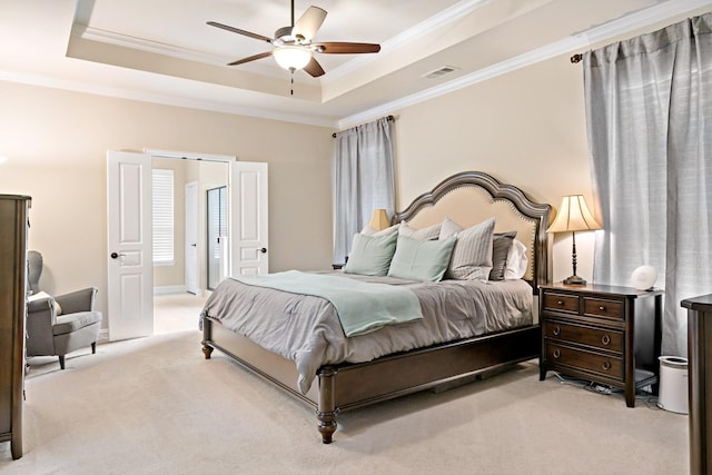 bedroom with crown molding, a raised ceiling, light carpet, and visible vents