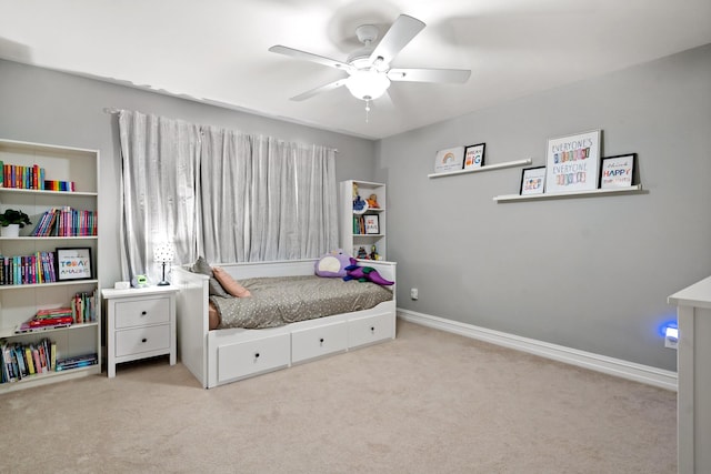 carpeted bedroom featuring baseboards and a ceiling fan