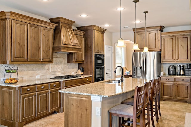 kitchen featuring gas cooktop, a kitchen breakfast bar, dobule oven black, a sink, and custom range hood